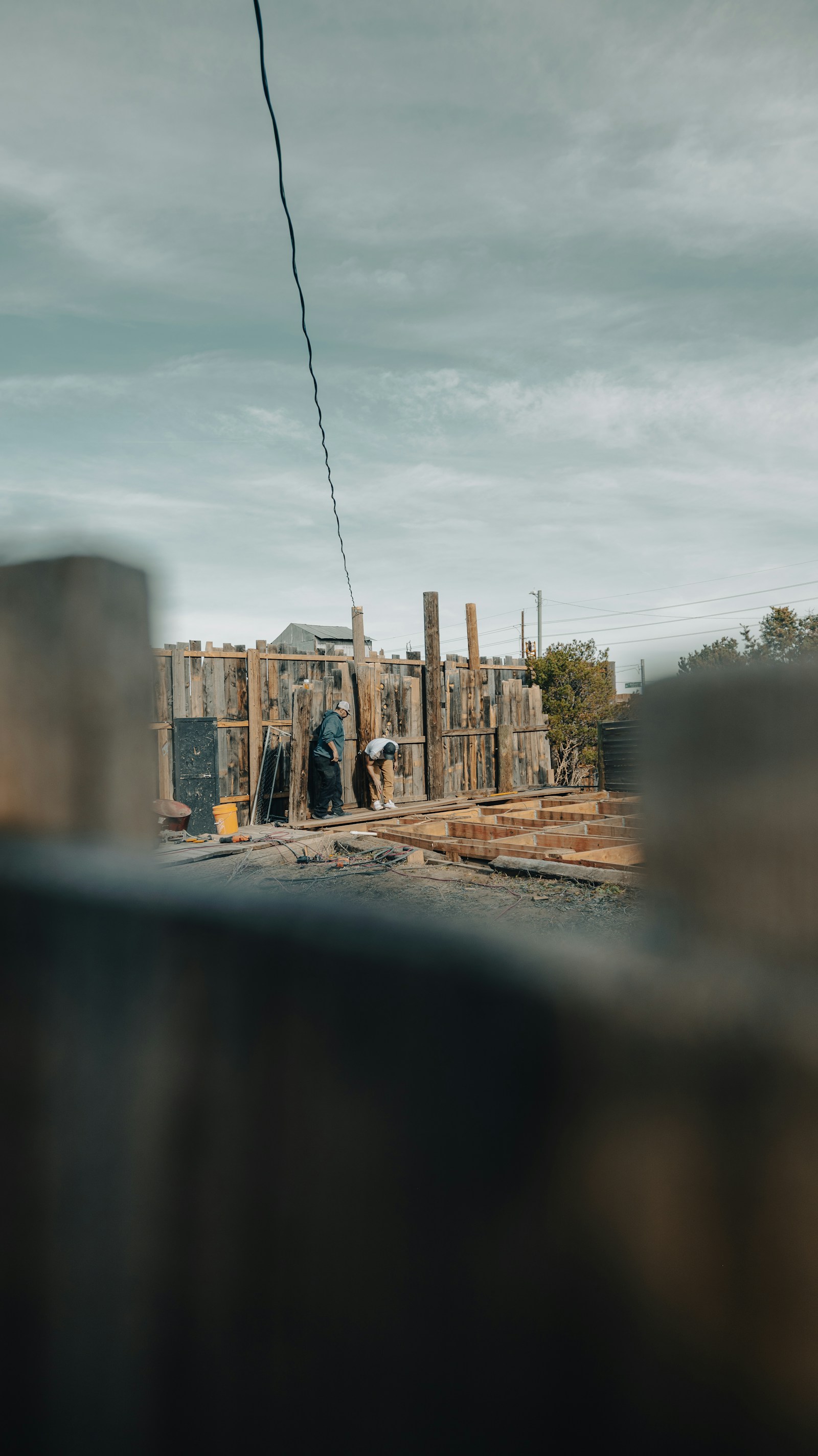 A contractor on a residential job looking at his phone