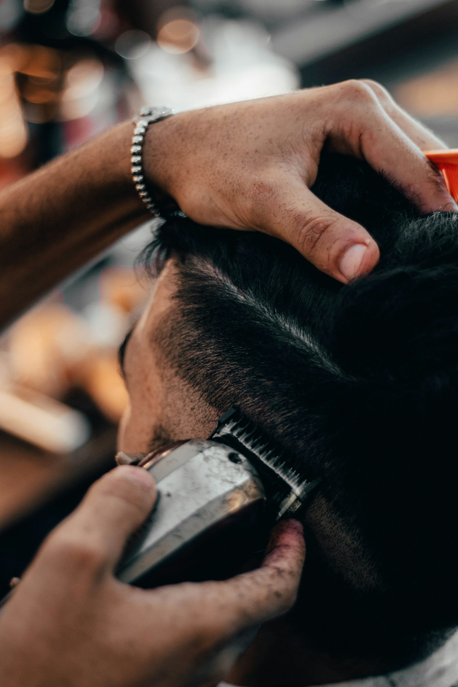 A stylist in a salon looking at a phone