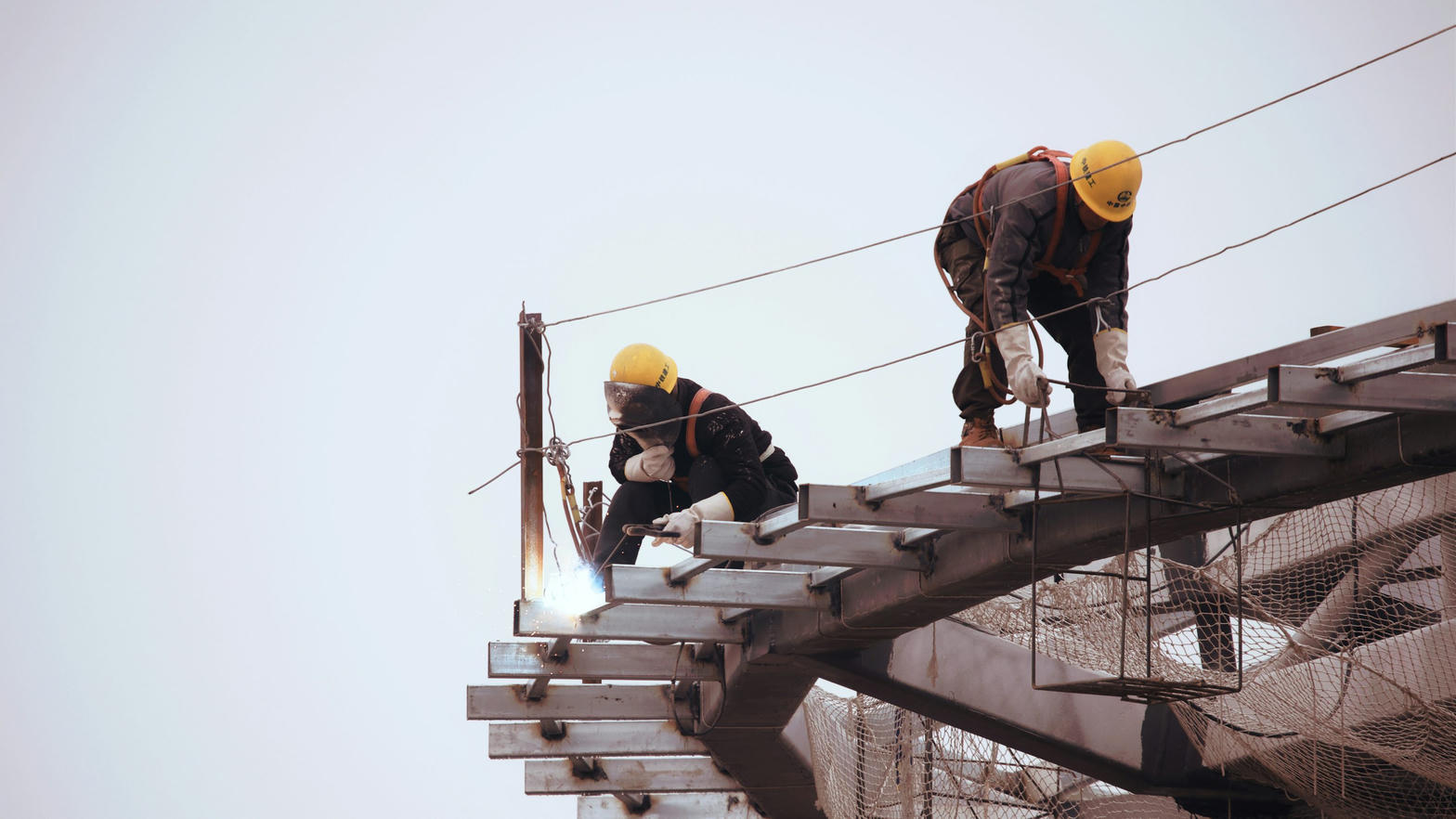 Welders working a steel connection on site